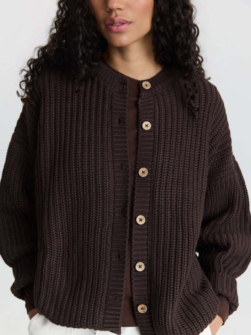 A hand-knit organic cotton cardigan in deep brown by The Simple Folk